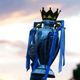 A Manchester City supporter holds up a replica of the English Premier League trophy as he celebrates outside the Etihad Stadium in Manchester, England, after his team clinched the title. City took the title after crosstown rivals Manchester United lost at home to Leicester City.